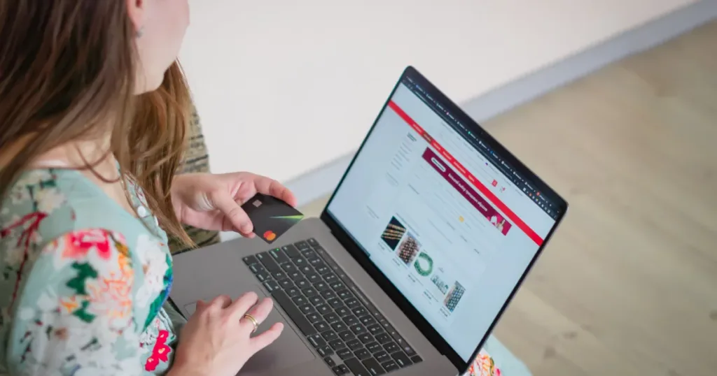 Woman shopping online with a laptop and card
